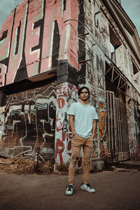 Portrait of man standing on abandoned building