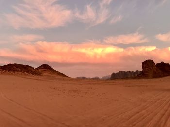 Scenic view of desert against sky during sunset