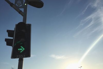 Low angle view of street light against blue sky