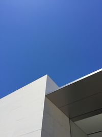 Low angle view of modern building against clear blue sky