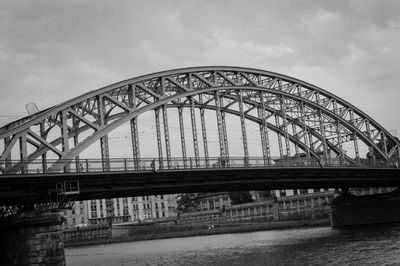 Low angle view of bridge against cloudy sky