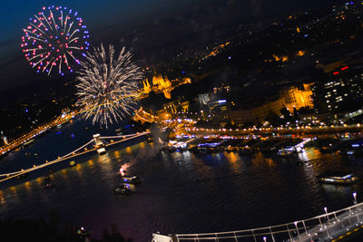 Firework display over city at night