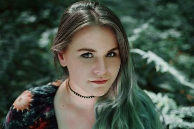 Portrait of beautiful young woman in forest