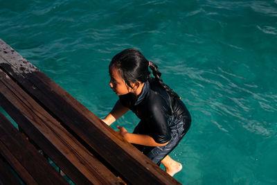 High angle view of woman looking at sea