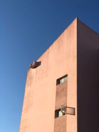 Low angle view of building against clear blue sky