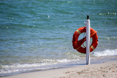 Red umbrella on beach against sea