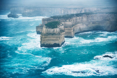 Aerial view of rocky coastline by sea