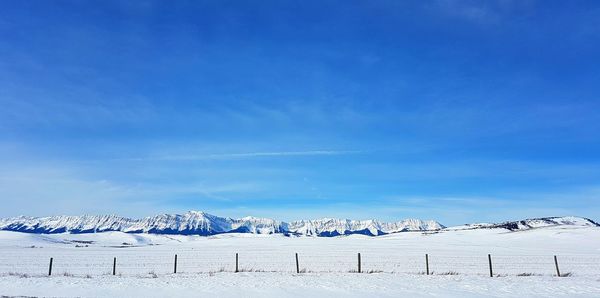 Scenic view of snow against blue sky