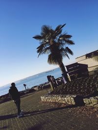 People in water against clear sky