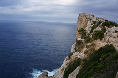 View of calm blue sea against cloudy sky