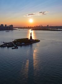 View of city at waterfront during sunset