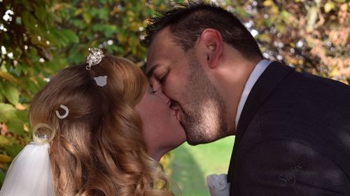 Close-up of bride and groom kissing outdoors