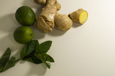 Close-up of fruits and leaves on table