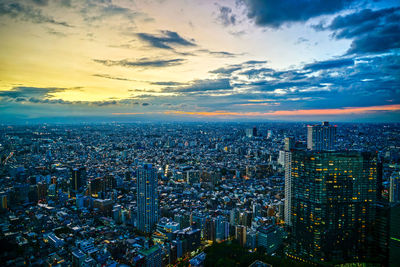 High angle view of city buildings against sky during sunset