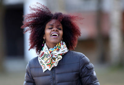 Portrait of smiling young woman standing outdoors