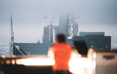 Rear view of woman standing in city