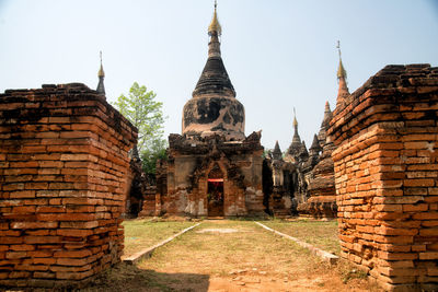 View of old temple against buildings