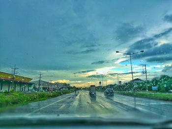 Cars on road against sky