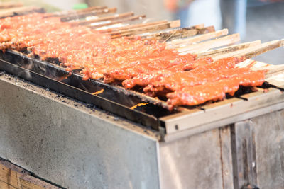 Close-up of meat roasting on grill