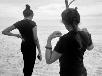 Rear view of women on beach