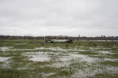 Abandoned bus on field