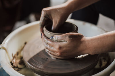 Close-up of artist making pot at workshop