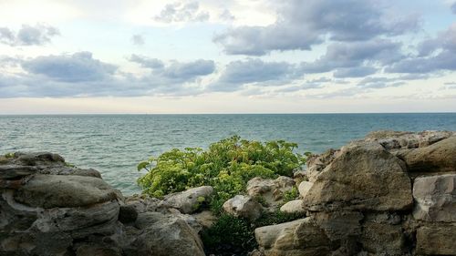 Scenic view of sea against cloudy sky