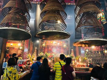 People in illuminated temple