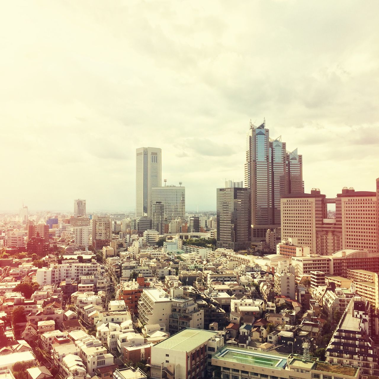 building exterior, architecture, built structure, cityscape, city, crowded, sky, residential district, cloud - sky, residential building, high angle view, skyscraper, residential structure, tower, cloudy, city life, tall - high, cloud, office building, day