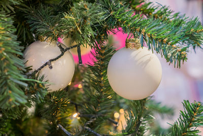 Close up of christmas tree decorated with white balls led garland. new year background
