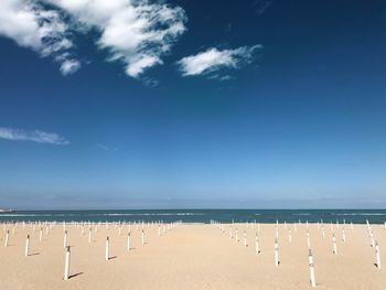 Scenic view of beach against blue sky