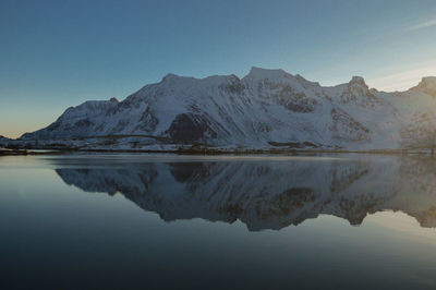 Scenic view of lake and mountains against sky during winter