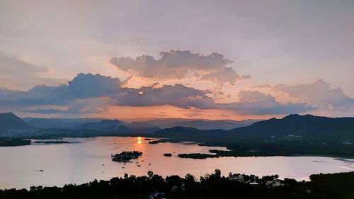 Scenic view of lake against sky during sunset