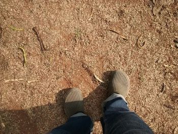 Low section of person standing on tiled floor