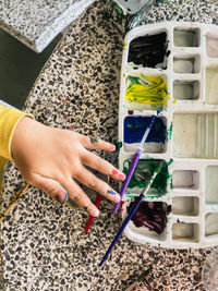 High angle view of woman holding hands at home