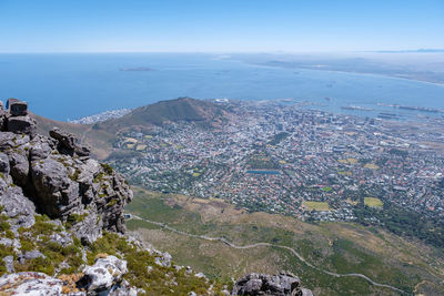 High angle view of townscape by sea against sky