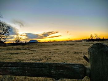 Scenic view of field against sky during sunset