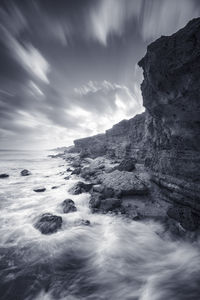 A man on the hills contemplating the wide seas and clouds . long exposure