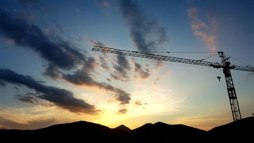 Low angle view of mountain against sky at sunset