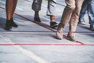 Low section of people walking on road