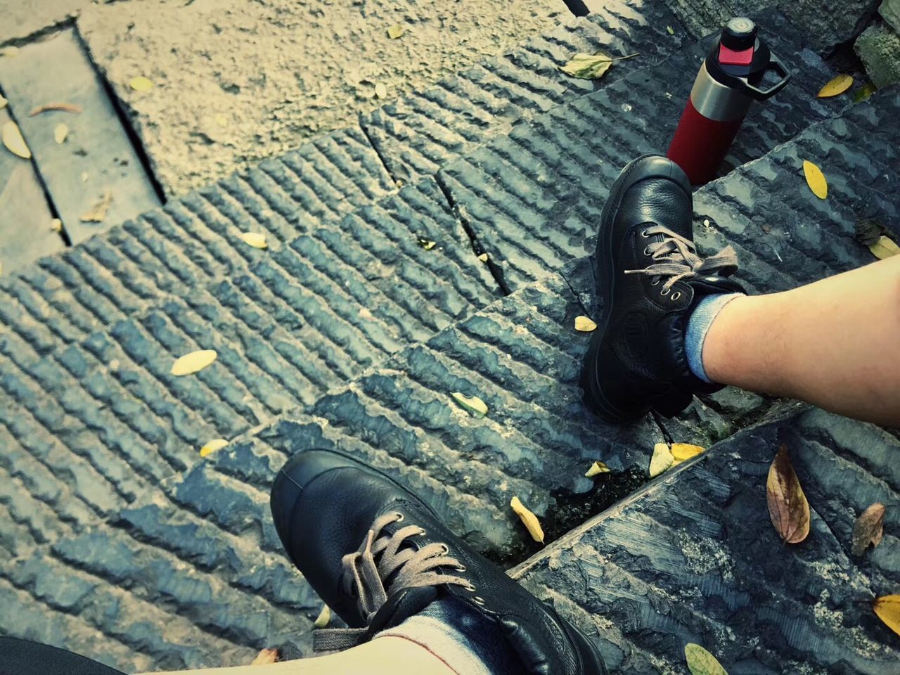 real people, human body part, shoe, low section, one person, personal perspective, body part, lifestyles, human leg, day, high angle view, footpath, leisure activity, street, men, outdoors, cobblestone, hand, human hand, paving stone, human foot, human limb