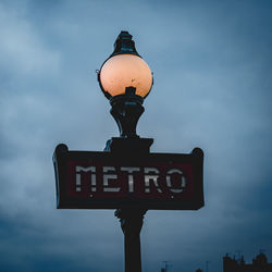 Low angle view of illuminated street light against sky