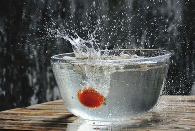 Close-up of fruit in bowl full of water on table