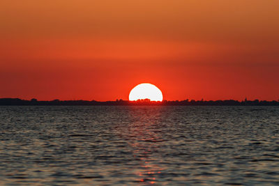 Scenic view of sea against romantic sky at sunset