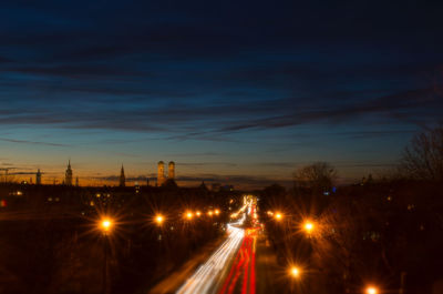 Light trails on road against sky at night