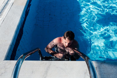 High angle view of woman swimming in pool