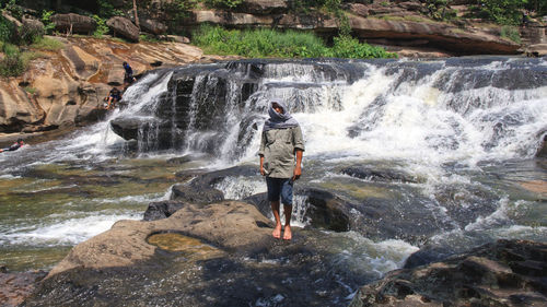 Full length of man standing on rock