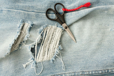 High angle view of scissors on jeans