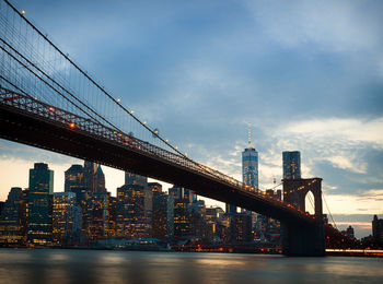 Manhattan bridge over east river and illuminated buildings at night view in new york city, usa.