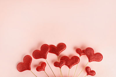 Red hearts on pink background. space for text, greeting card